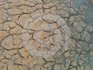 Dry cracked mud texture with deep crevices