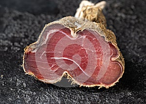 Dry cured beef bresaola meat cut with herbs