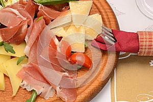 Dry-cured pork slices, tomato and cheese