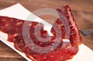 Dry-cured Spanish ham, Serrano ham, Bellota ham, Italian prosciutto crudo or Parma ham, wagyu slice