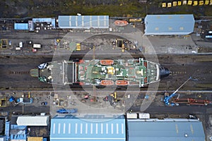 Dry dock and ship with shipbuilding in construction activity aerial view from above Greenock UK photo