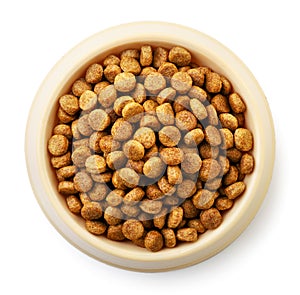 Dry dog food in bowl on white background, isolated. The view from top