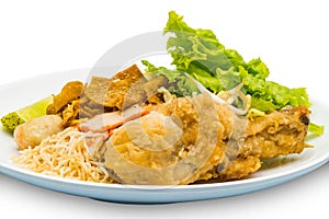 Dry egg noodle topping with fried chicken drumstick, bean sprout