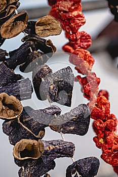 Dry eggplant and dry bell chili hanging in the market, local ingredient, closeup selective focus on blurred background