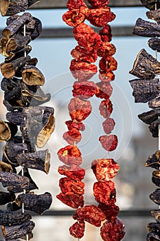 Dry eggplant and dry bell chili hanging in the market, local ingredient, closeup selective focus on blurred background