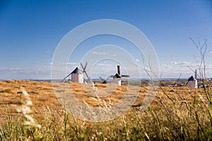 Dry field with ancient windmill in Campo de Criptana, Spain,