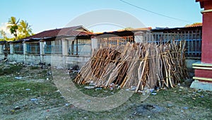 Dry firewood lying on the fence in Venilale market, Timor-Leste photo