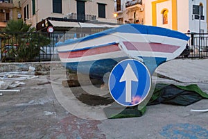 Dry fishing boat with a road sign