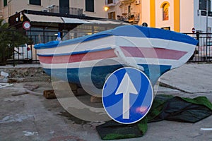 Dry fishing boat with a road sign