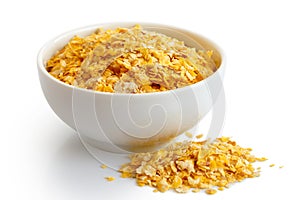 Dry flaked corn in white ceramic bowl. photo