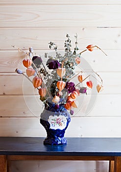 Dry flowers in a dark blue vase