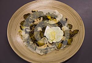 Dry flowers in a wooden plate photo