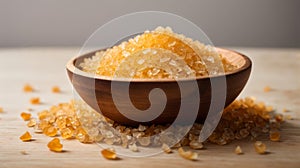 Dry gelatin granules in a wooden bowl on a white background.