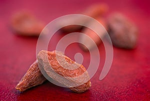 Dry goji berries (Lycium barbarum) on red background