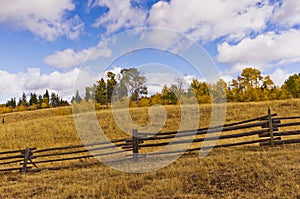 Dry golden rangeland and wood fence