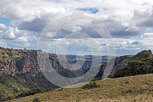 Dry Grassland Gorge Mountains and Valleys Against Cloudy Sky