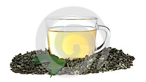 Dry green tea leaves and cup of aromatic beverage on white background