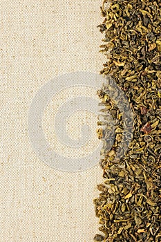 Dry green tea leaves on a sackcloth