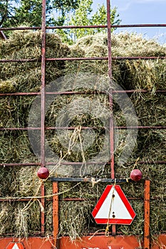 Dry Hay Stacks into a Transportation Truck