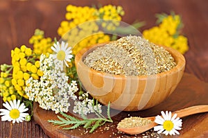 Dry herbal tea in wooden bowl