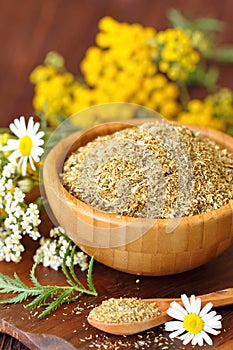 Dry herbal tea in wooden bowl