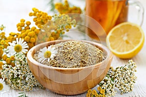 Dry herbal tea in wooden bowl