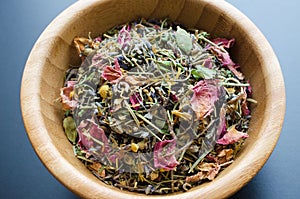 Dry herbal tea in wooden bowl