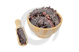 Dry hibiscus tea in wooden bowl and scoop isolated on white background. herb. herbal tea. food ingredient