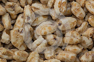 Dry honey puffed wheat cereal pieces scattered loosely directly above image.