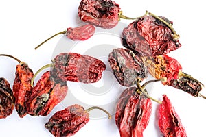 Dry hot chilly pepper on a white paper photo