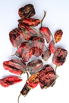 Dry hot chilly pepper on a white paper photo