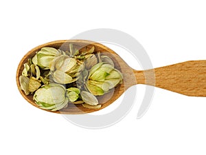 Dry Humulus in wooden spoon on white background