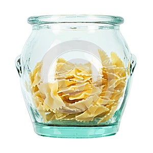 Dry Italian pasta macaroni bows farfalle in glass jar isolated on white background