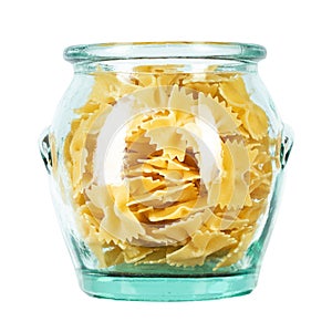 Dry Italian pasta macaroni bows farfalle in glass jar isolated on white background