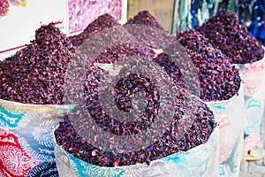 Dry karkade tea leaves in the wicker basket on the street market. Hurgada. Egypt