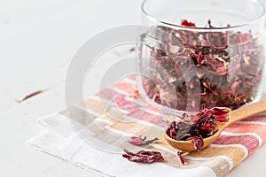Dry karkade tea, white wood background