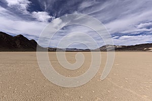 Dry lake bed in desert with cracked mud on a lake floor