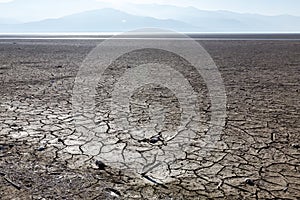 Dry lake bed with natural texture of cracked clay in perspective