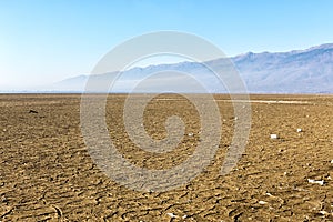 Dry lake bed with natural texture of cracked clay in perspective