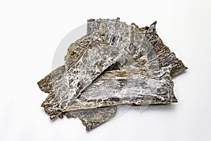 Dry laminaria japonicaï¼ˆkelpï¼‰Isolated on white background. Kombu seaweed, traditional Japanese ingredient for cooking Dashi