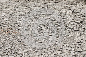 Dry land soil or cracked ground texture and parched dirt in Thailand.Mosaic pattern of sunny dried earth soil.Desert,Global warmin