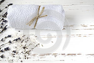 dry lavender flowers with soap, towel and sea salt on vintage wooden table. spa treatments