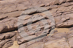 Dry Layered Rocks on Beach at Low Tide