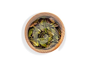 Dry leaves of Arctostaphylos in a wooden Cup on a white background photo