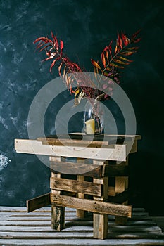 Dry leaves in a vase. vintage interior. dark background.autumn