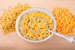 Dry Macaroni and Grated Cheese with Bowl of Mac n Cheese photo