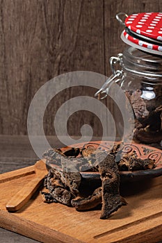 Jar with mushrooms, dry mushrooms on an old oak board