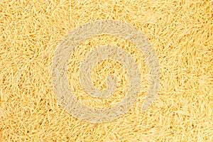 Dry noodles texture, yellow pasta vermicelli background