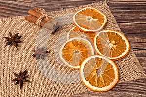 Dry orange oranges. Dried citrus fruits. Tropical fruit. On a brown background.