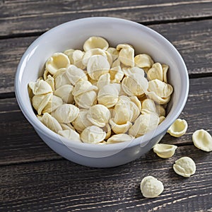 Dry orecchiette pasta in a ceramic bowl